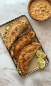 Crispy smash burger tacos with melted cheese, caramelised onions and cheeseburger sauce