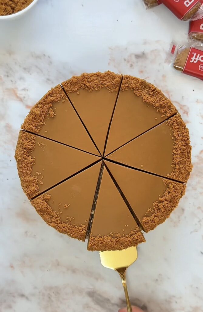Creamy Biscoff cheesecake topped with melted Biscoff spread and crushed Biscoff biscuits
