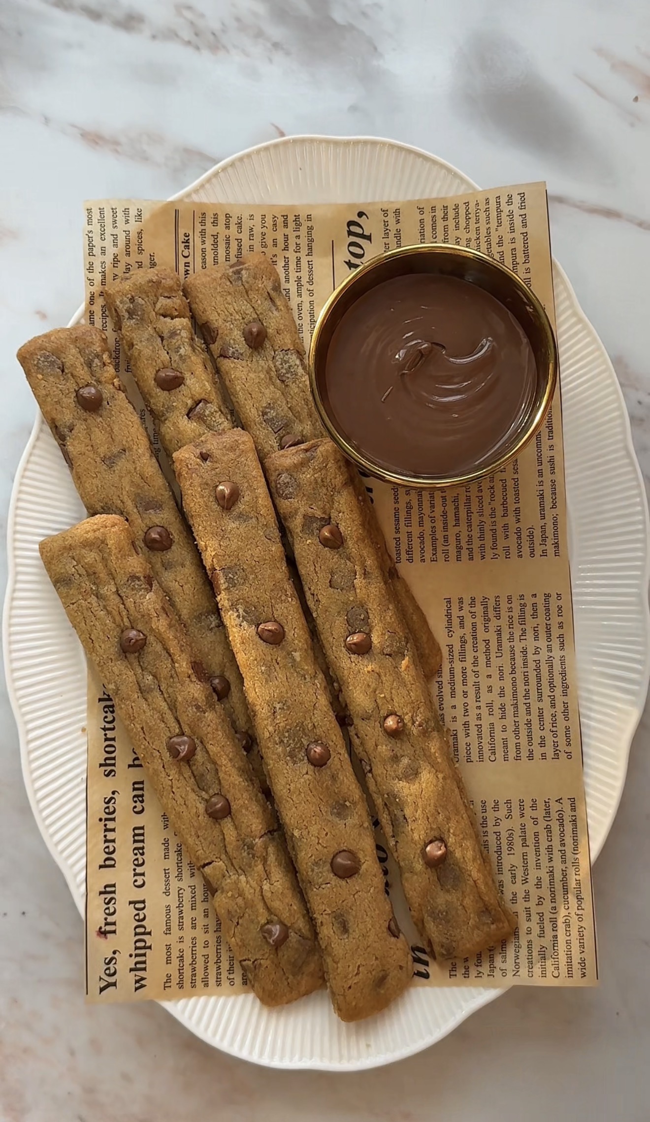 Golden chocolate chip cookie fries arranged like French fries with mini chocolate chips