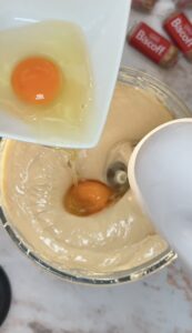 add eggs to the cheesecake filling