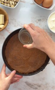 making the crust for the base of the cheesecake