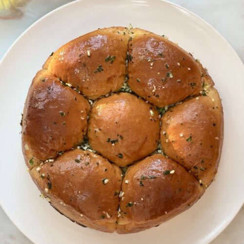 Soft fluffy Japanese milk bread rolls brushed with garlic butter in a springform pan